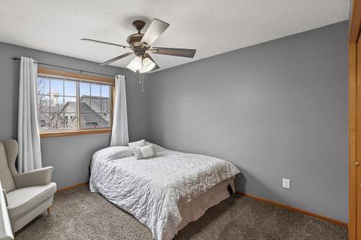 Bright upper-level bedroom with neutral finishes