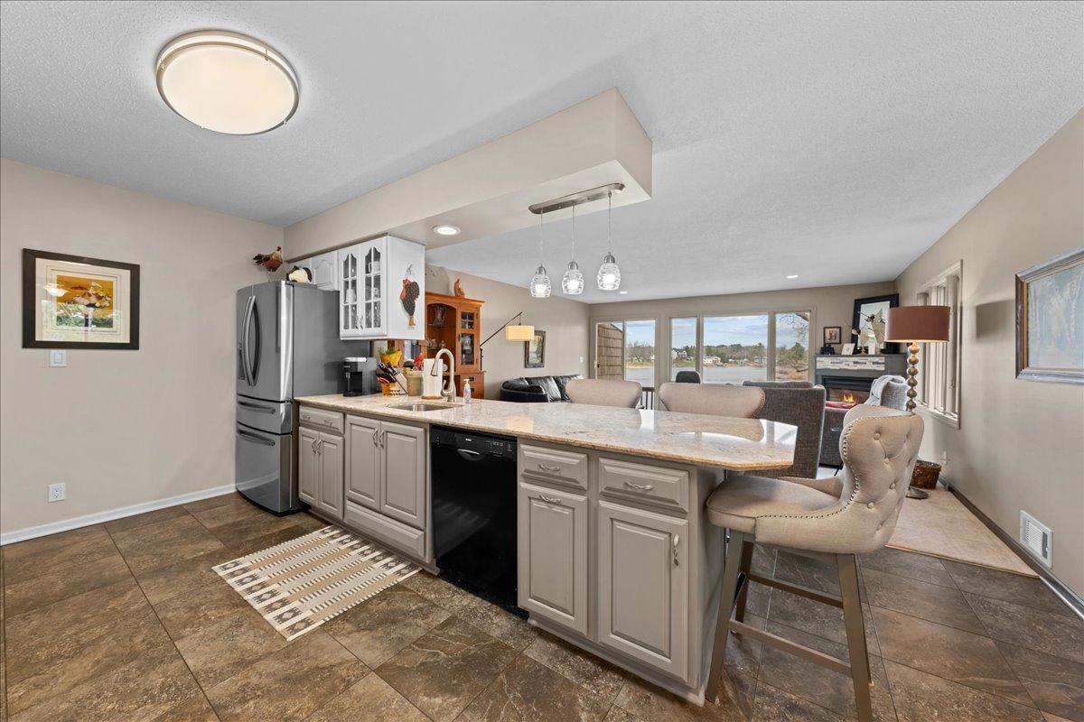 Solid surface counter top; a nice gathering space and separate dining area for a crowd