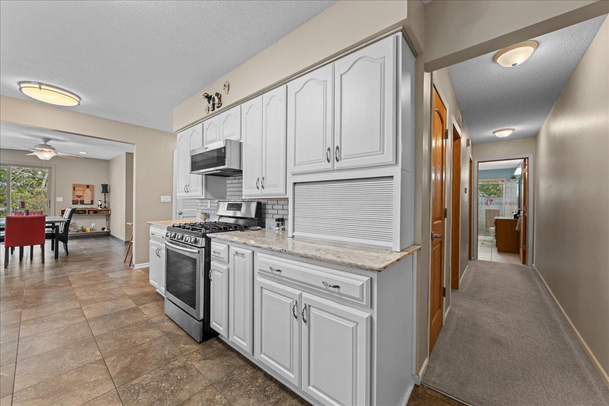 The hallway shown leads to Primary bedroom and bathroom with a walk in closet