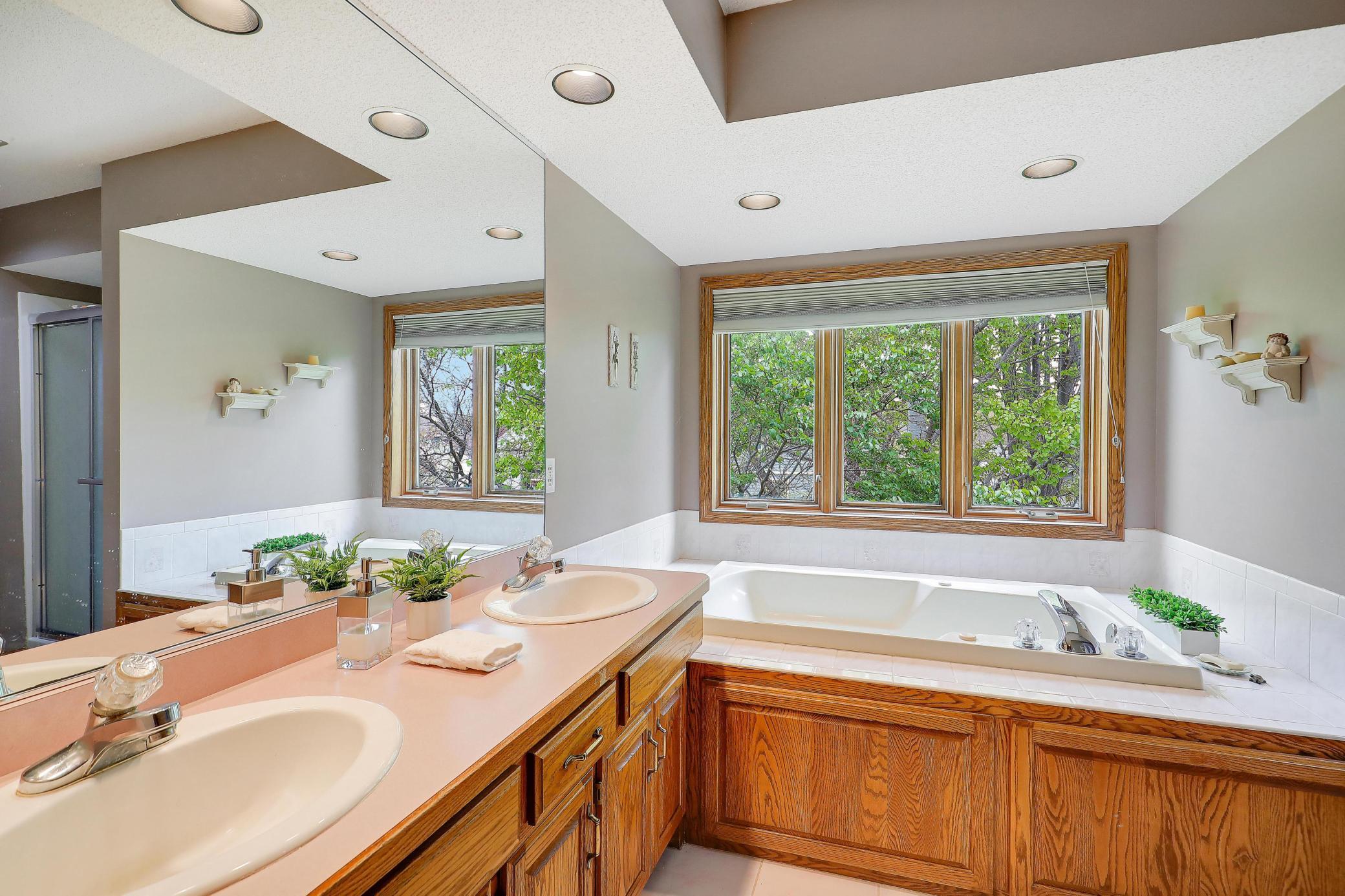 Primary ensuite complete with jacuzzi bath and private shower.