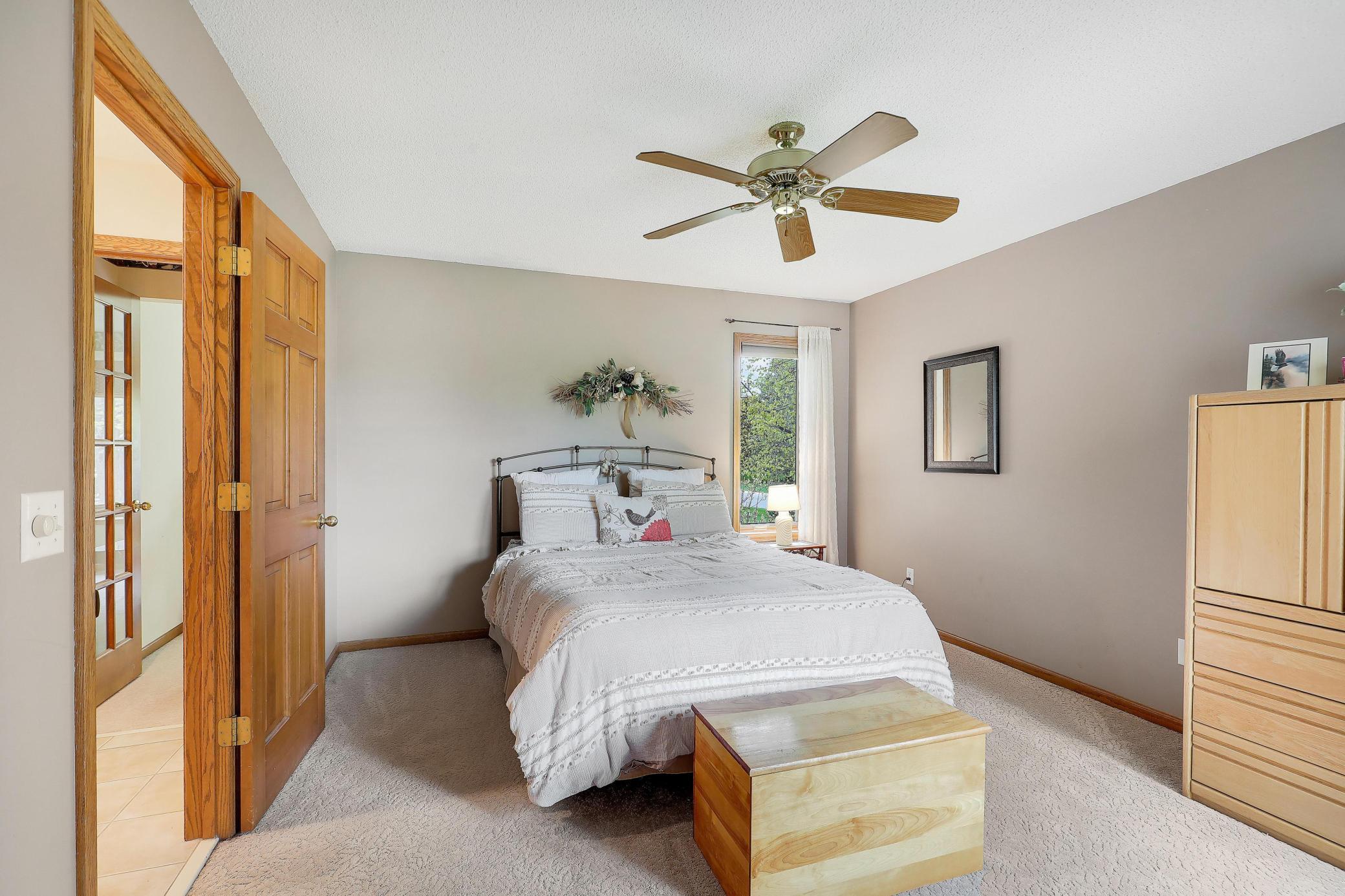 Spacious primary bedroom with ceiling fan.
