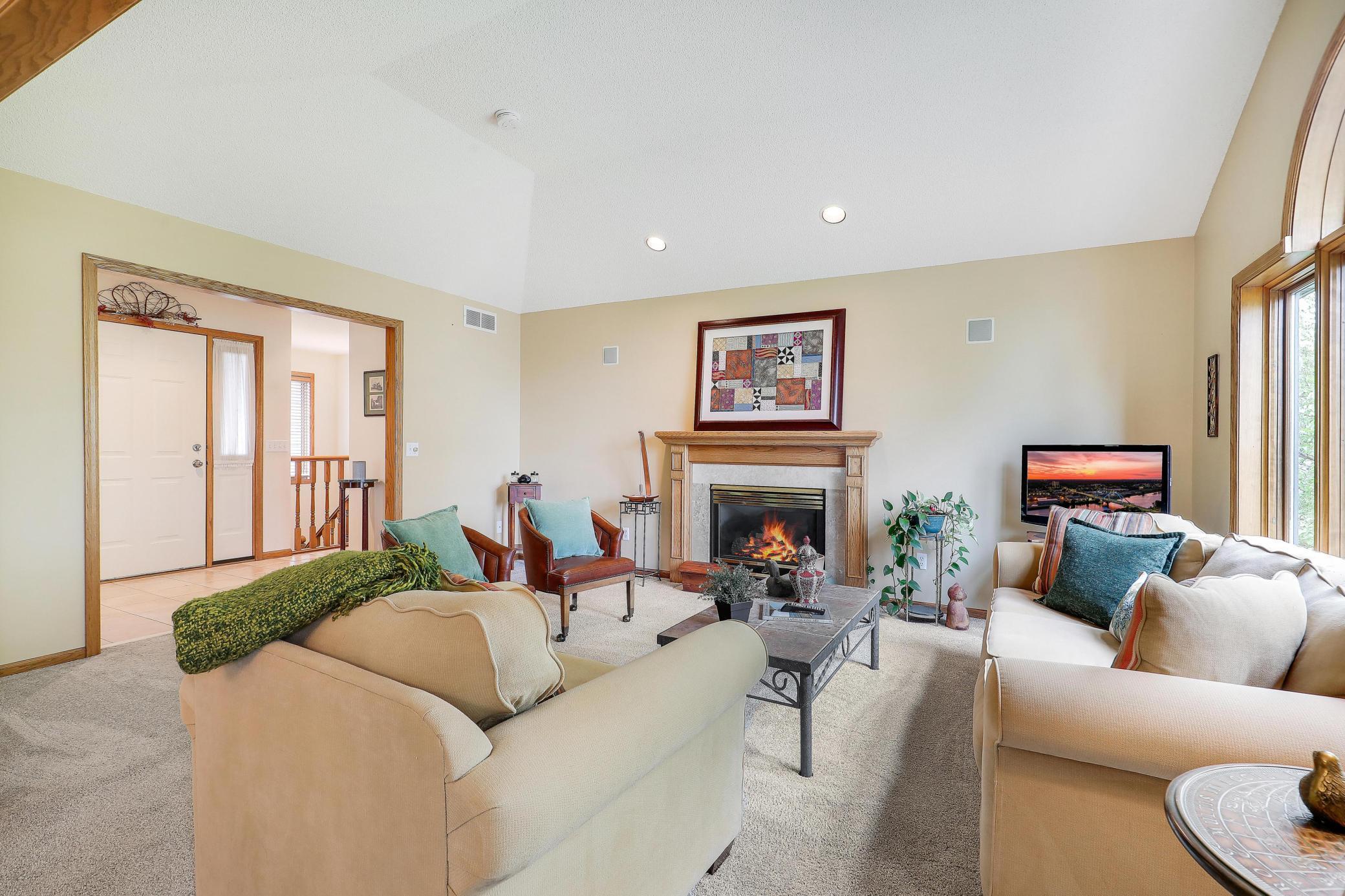 Another view of lovely living room with big windows overlooking the backyard.