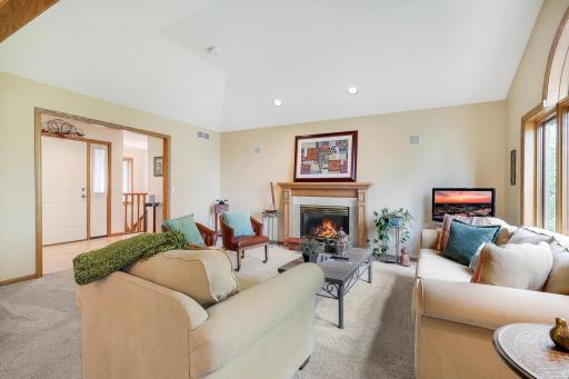 Another view of lovely living room with big windows overlooking the backyard.