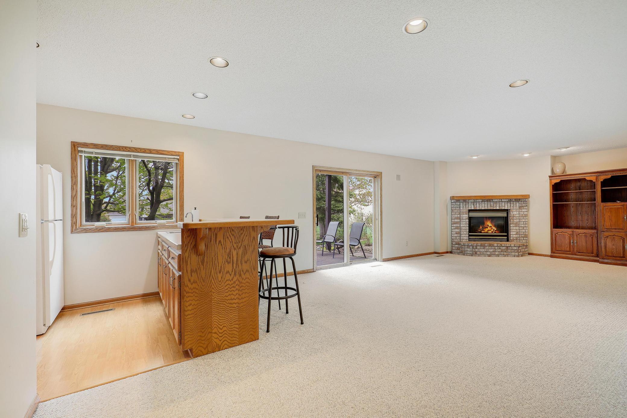 A wet bar and gorgeous gas fireplace with walkout to paver patio.