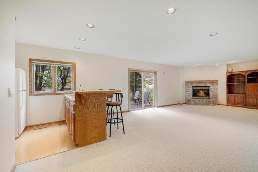 A wet bar and gorgeous gas fireplace with walkout to paver patio.