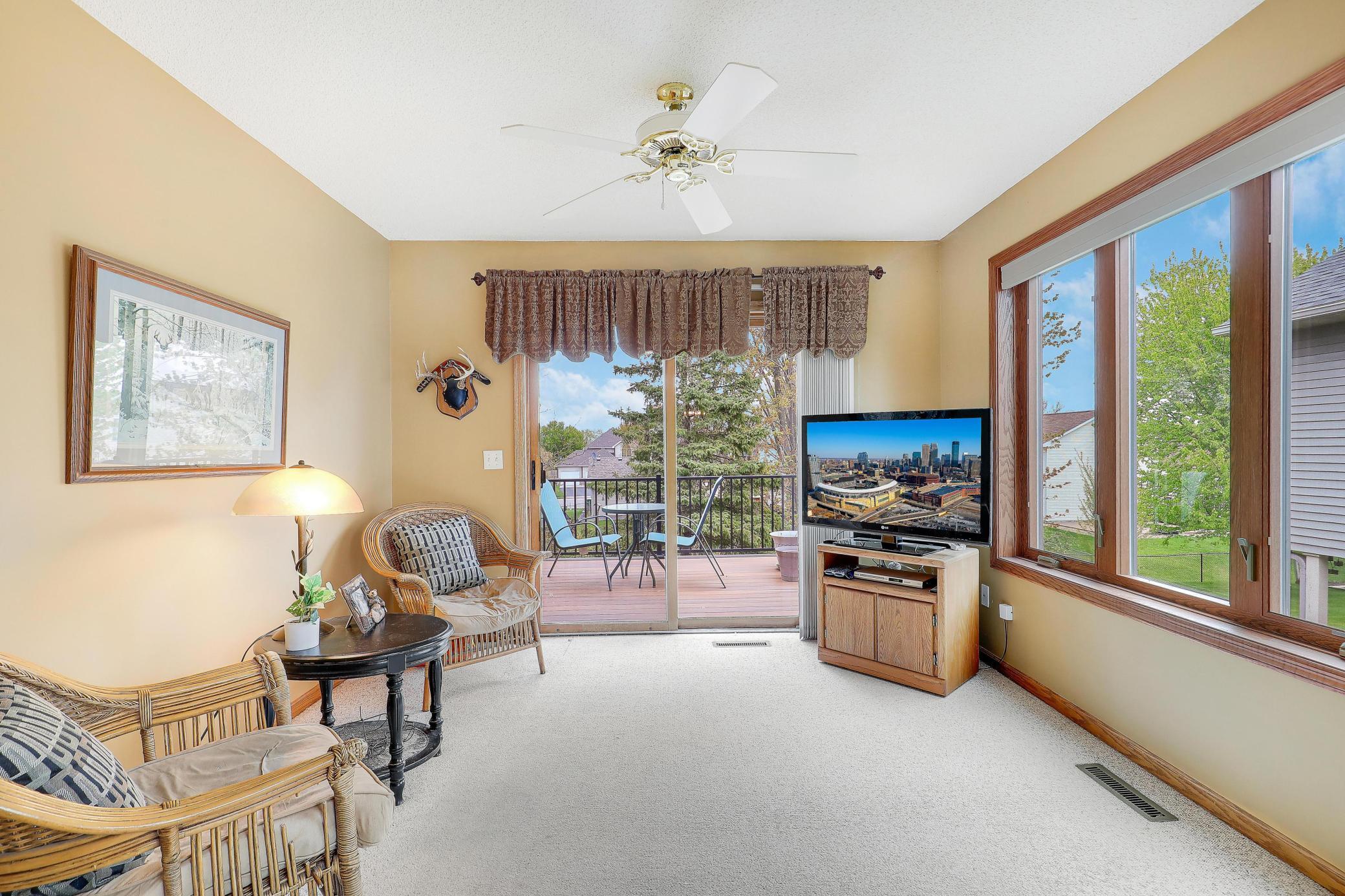 Bright and cozy sun room leading out to maintenance free deck.