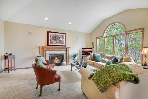 Living room boasts a beautiful gas burning fireplace with vaulted ceilings and huge windows overlooking the backyard!