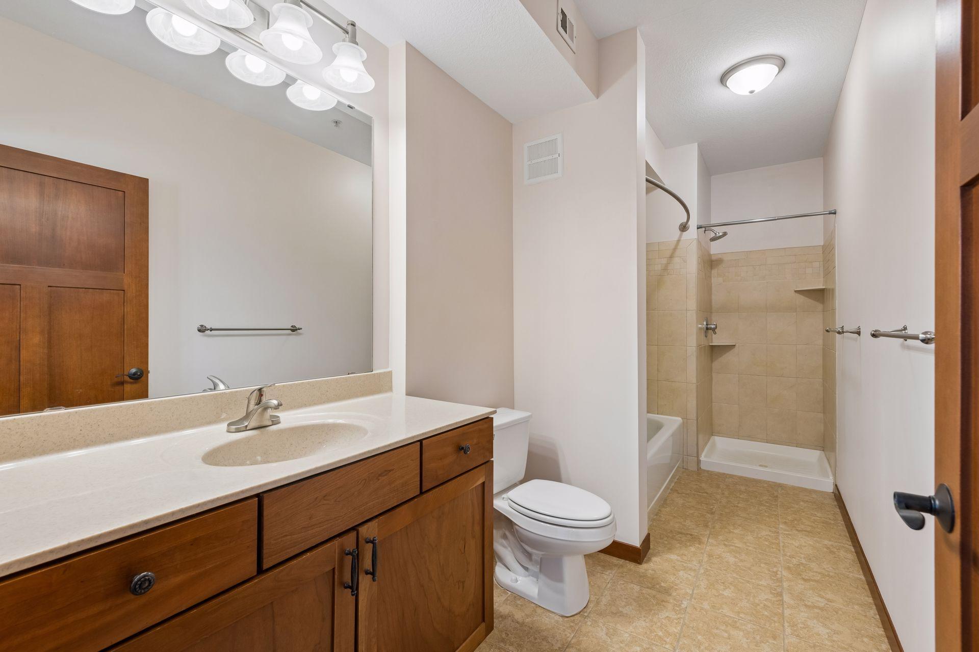 Private primary bath with separate tub and tile walk-in shower.