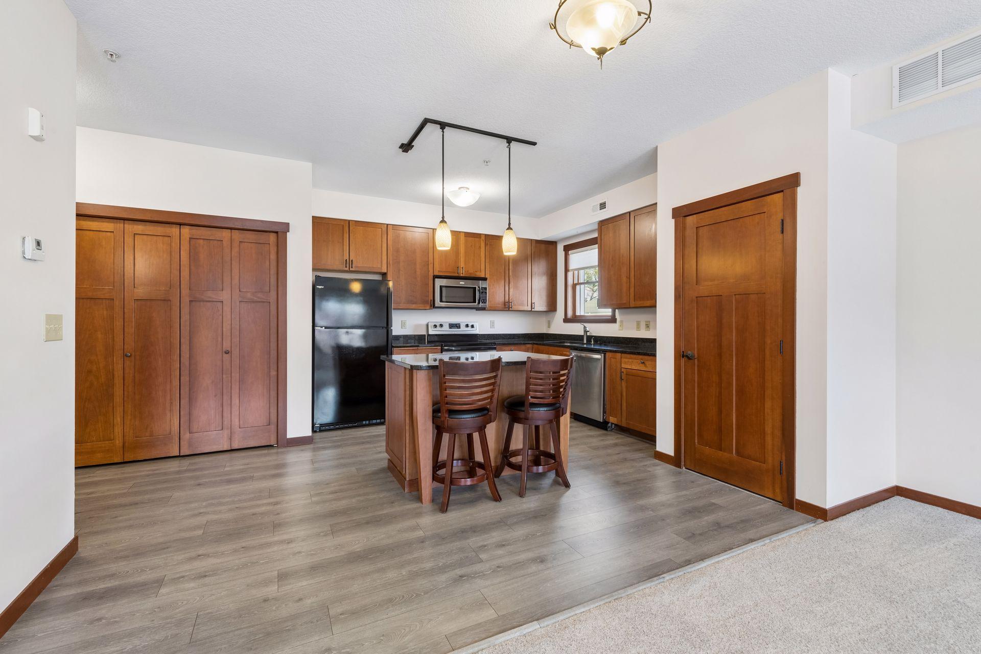 Modern and sleek kitchen with high end finishes: cherry cabinetry, granite counters, and stainless appliances.