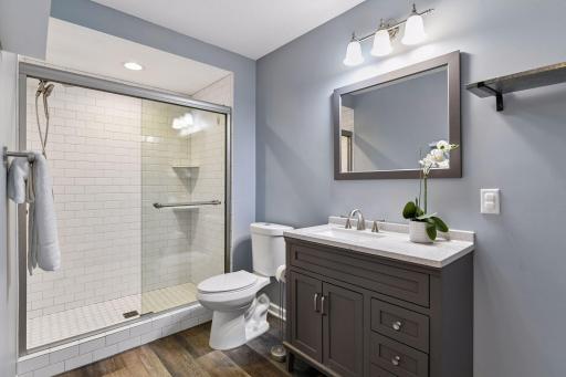 Updated lower level bathroom with a tiled walk-in shower
