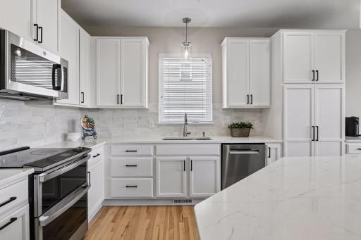 Kitchen with stainless appliances and quartz-look counters