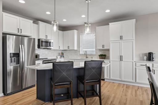White cabinetry, stainless appliances, and refinished cabinets