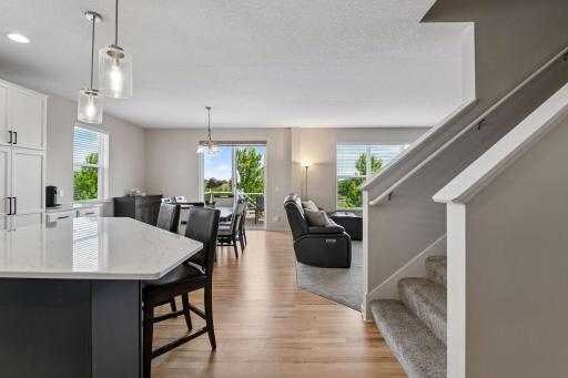 Open main level flowing from dining to living, with staircase access