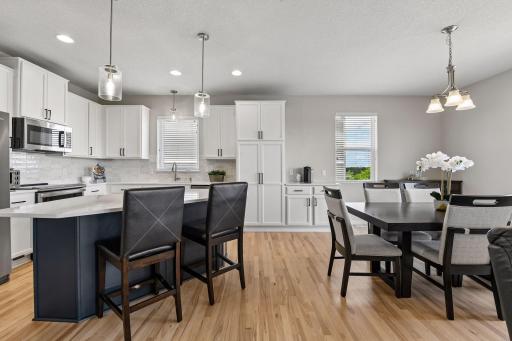 Updated kitchen open to a casual dining space, with island seating