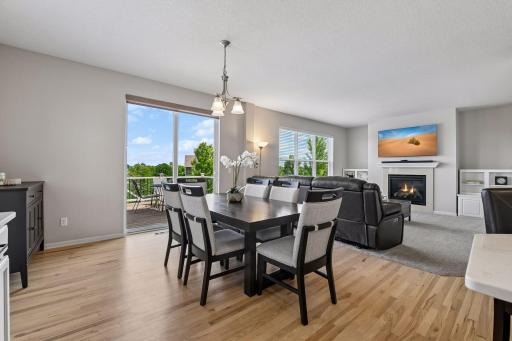 Dining and living areas open to each other, with deck access and a gas fireplace