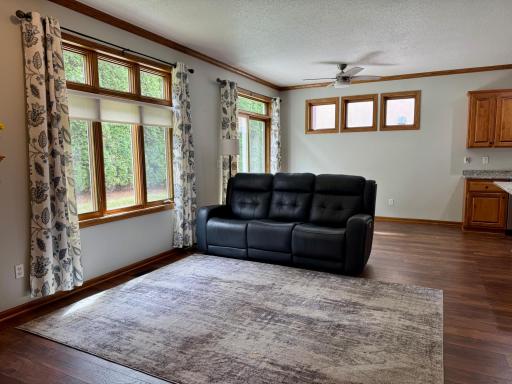 Sun-Drenched, Open-Concept Living Area With Elegant Transom Windows Overlooking The Backyard And Patio!