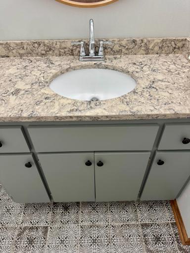 A fully updated modern bathroom, showcasing high-end finishes like designer tile flooring and premium quartz countertops for a clean, fresh look!