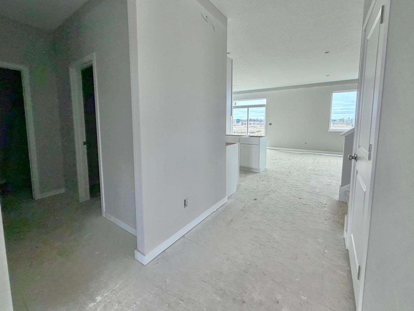 3199 Jandura Ave NE- Photo of actual home. Main floor hallway view to the mudroom including half bath and walk-in closet.