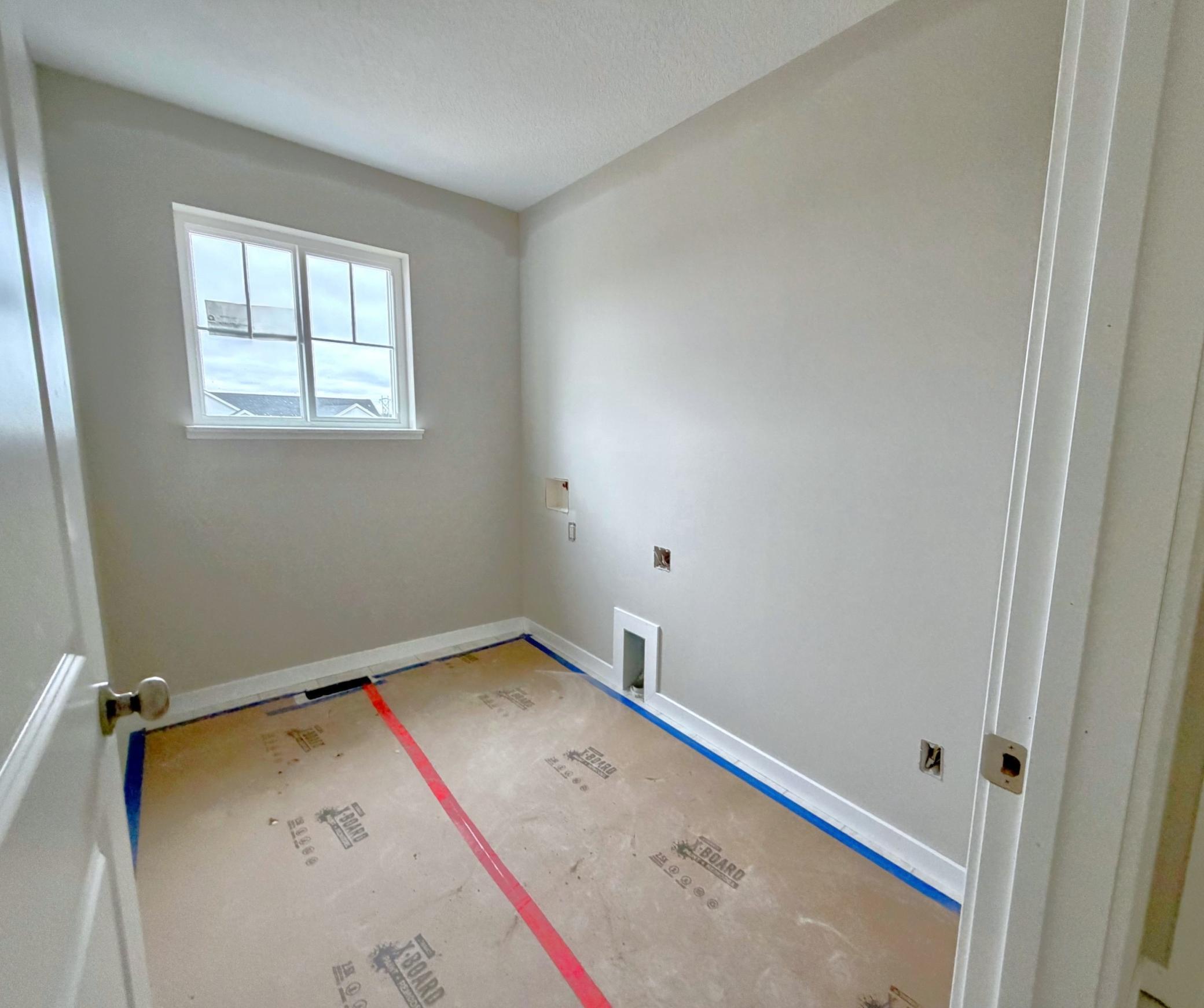 3199 Jandura Ave NE- Photo of actual home. Upper floor Laundry Room features a window.