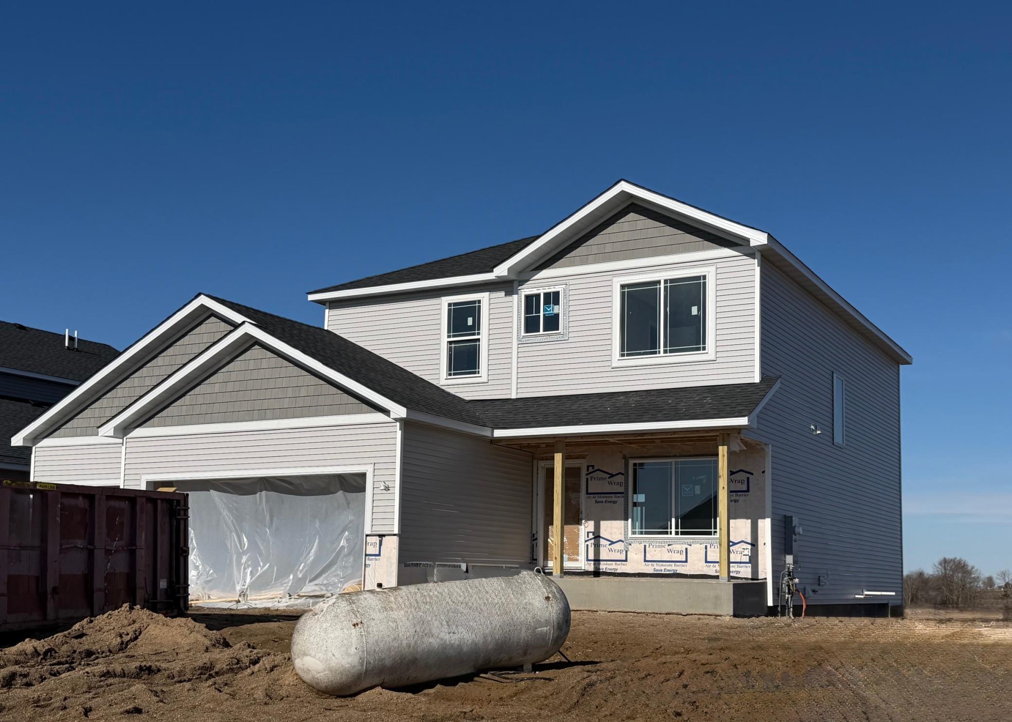 3199 Jandura Ave NE- Photo of actual home under construction. Siding installation will be completed and stone accents installed soon. Home will be ready for Move-in on 5/19/2026! Sod, Irrigation System, and Front Plantings included.