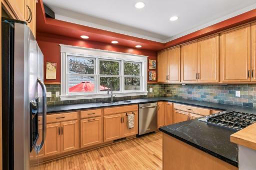 Gourmet kitchen with new stainless steel appliances,soapstone countertops and huge window looking out to very private yard.