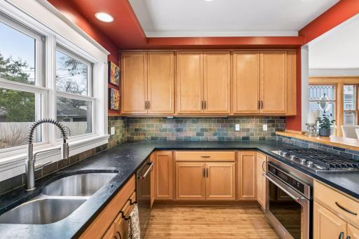 Slate backsplash ,lots of cabinets with custom pullouts .