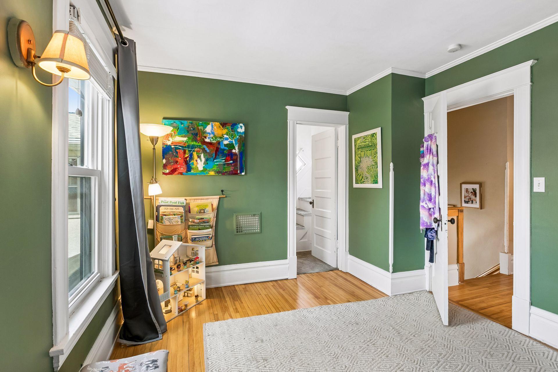 Walk in closet straight ahead with stairs to a walk up unfinished attic .