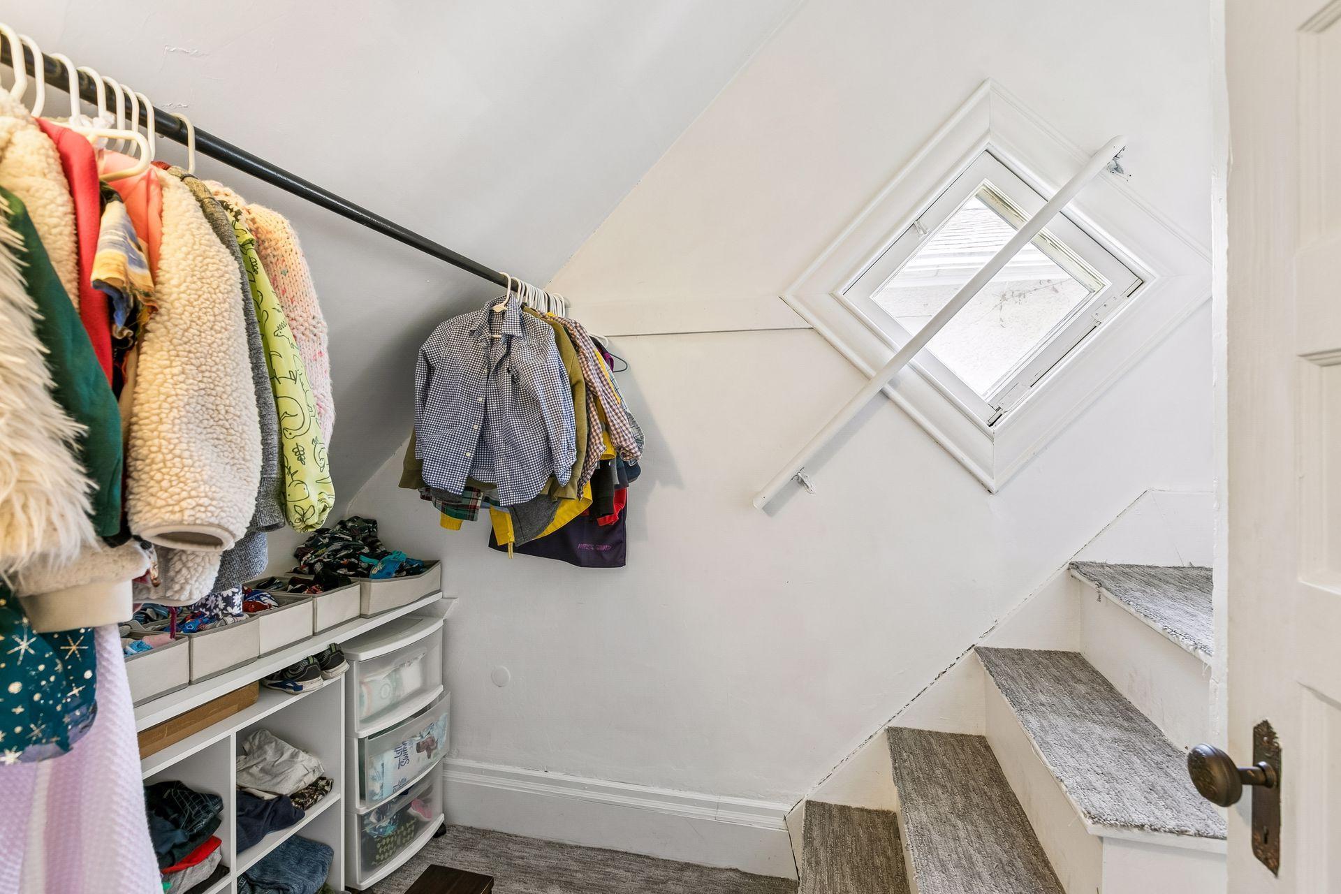 Bedroom #3 closet with stairs leading to attic.