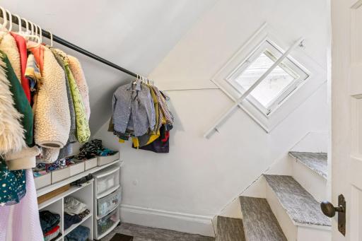 Bedroom #3 closet with stairs leading to attic.