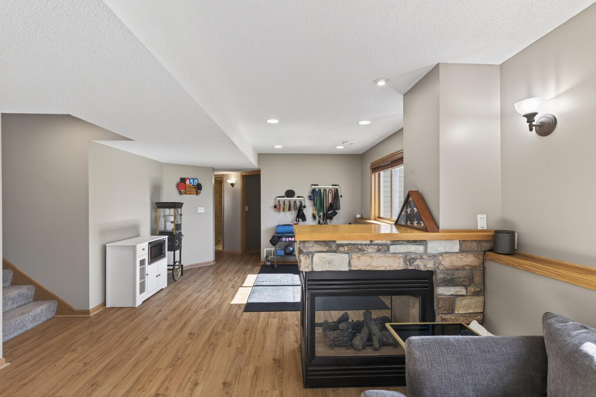 Recess Lighting, Stone Fireplace Surround and wood ledges add character to this space