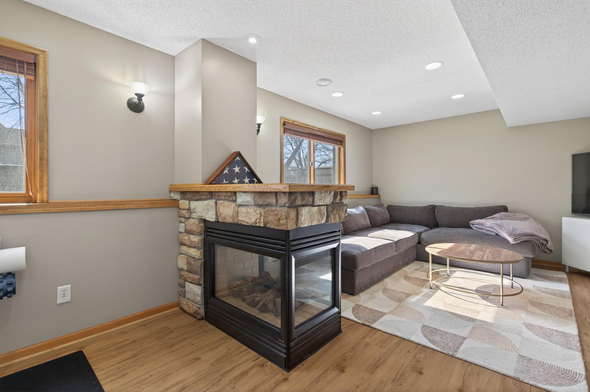 Lower level newer flooring, Family Room/ game- rec room combo separated by a 3 way gas fireplace