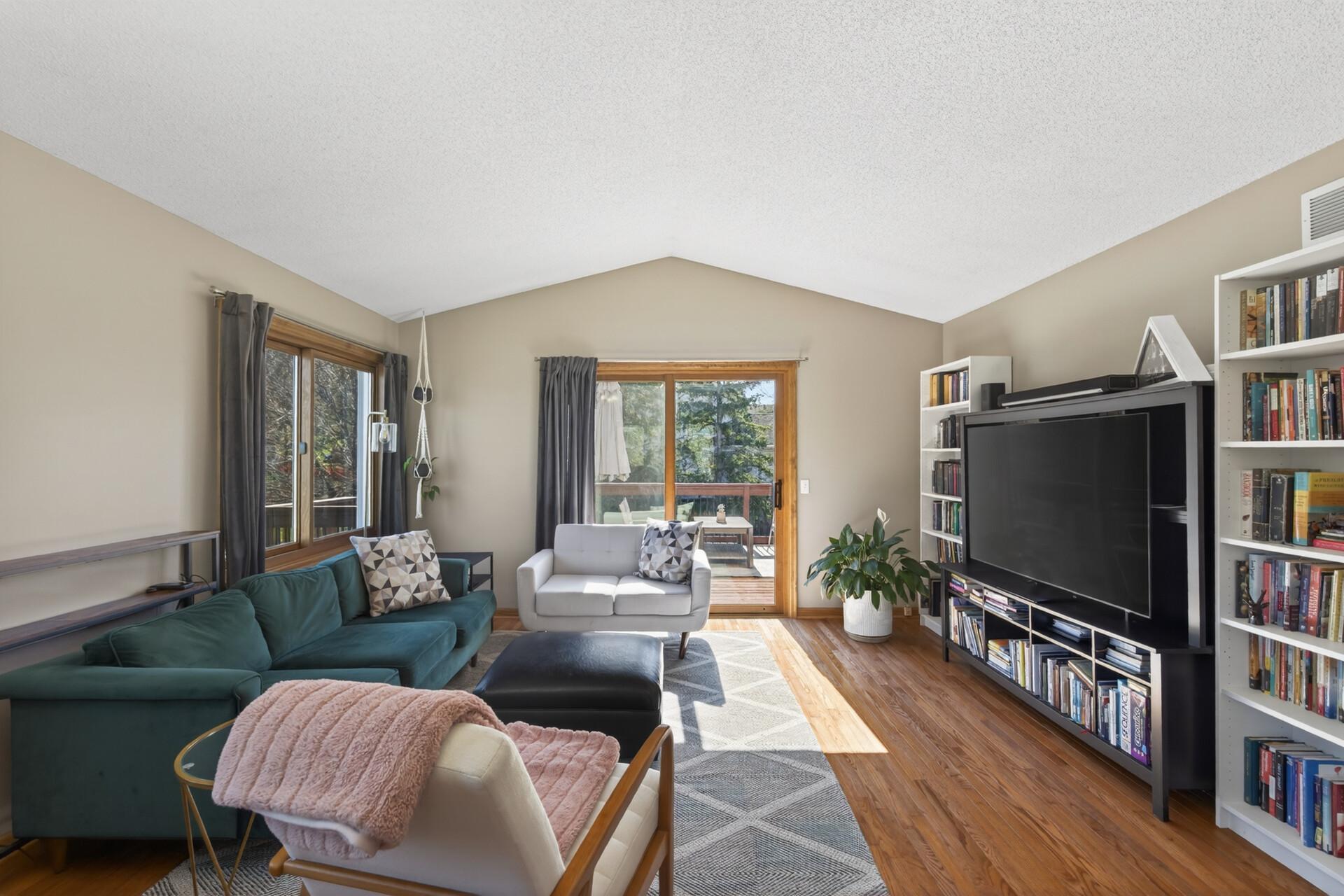 Walk-out patio door to deck overlooking private backyard