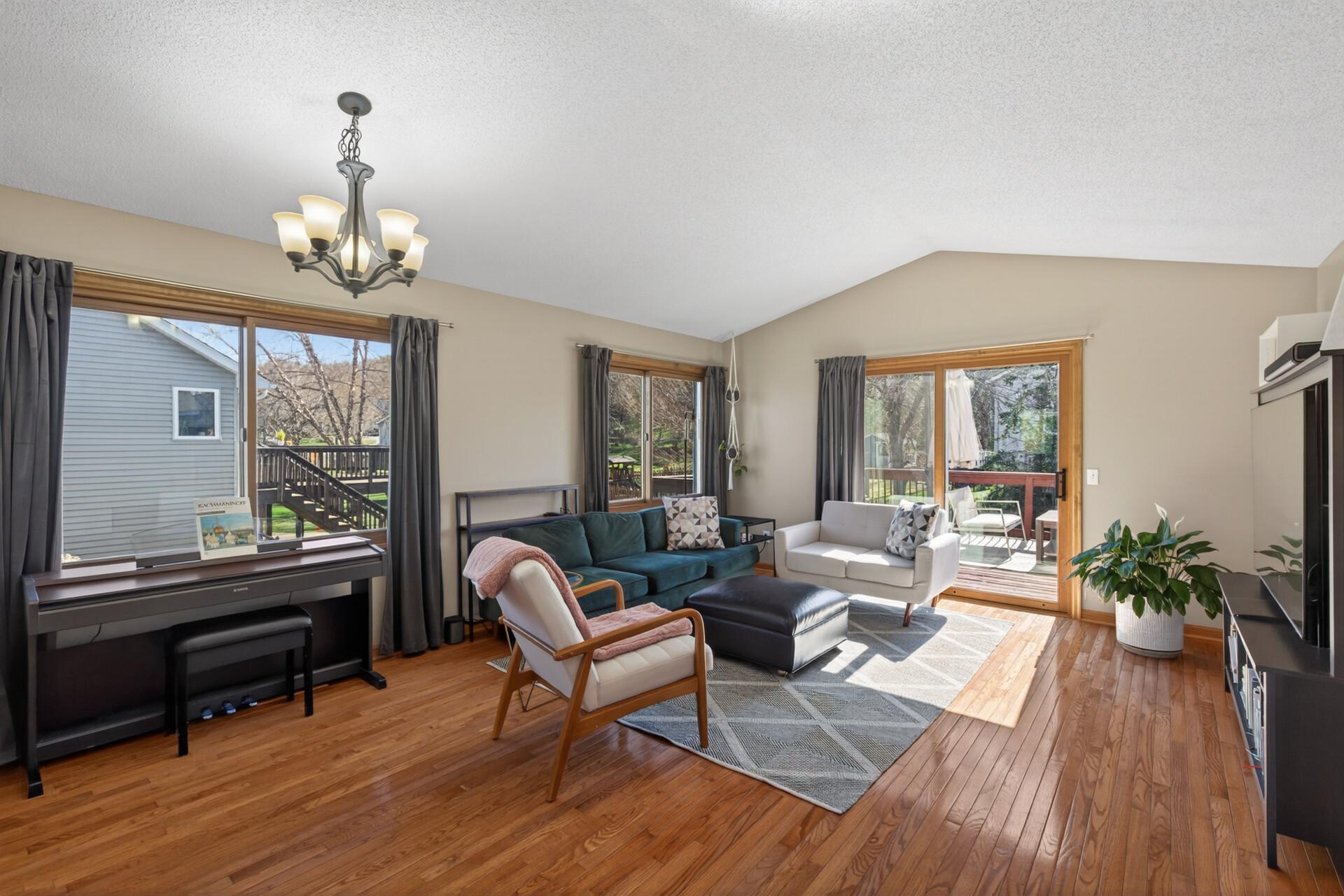 Inviting wood floors, vaulted ceilings and may be utilized as a Living/ Dining room area or one large Living Room