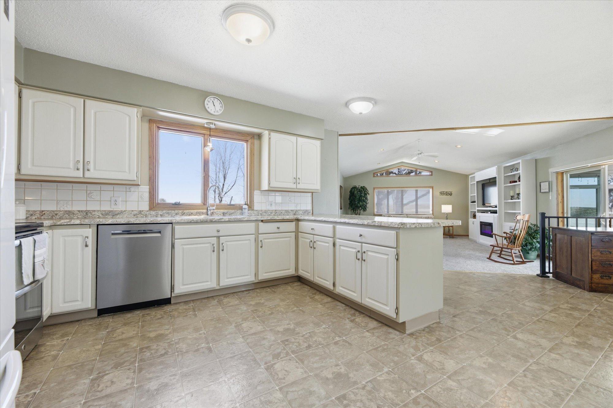 Kitchen features SS range and dishwasher.