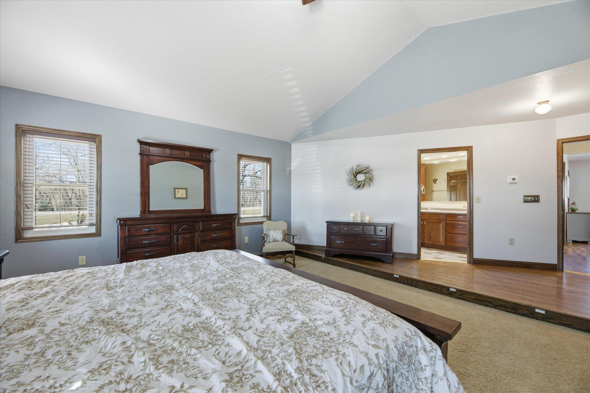 Primary Suite features walk in closet and private bath with walk in shower.