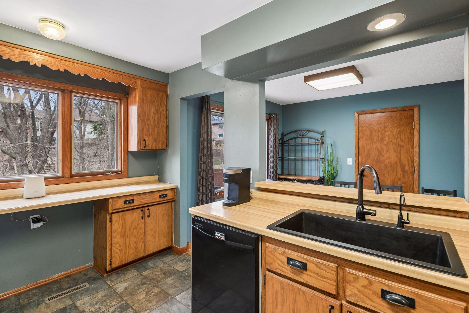 The kitchen window overlooks the expansive back yard