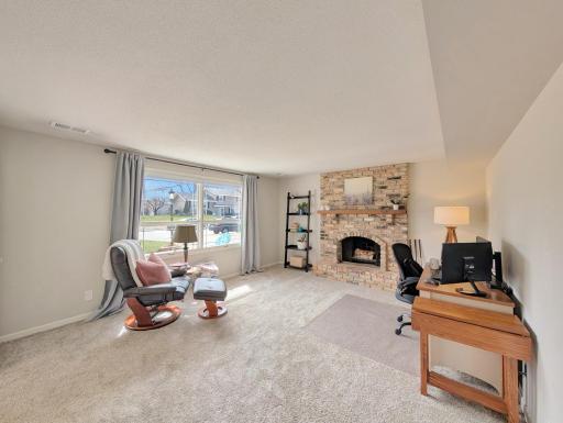 This stunning fireplace makes this family room or study feel cozy and warm.