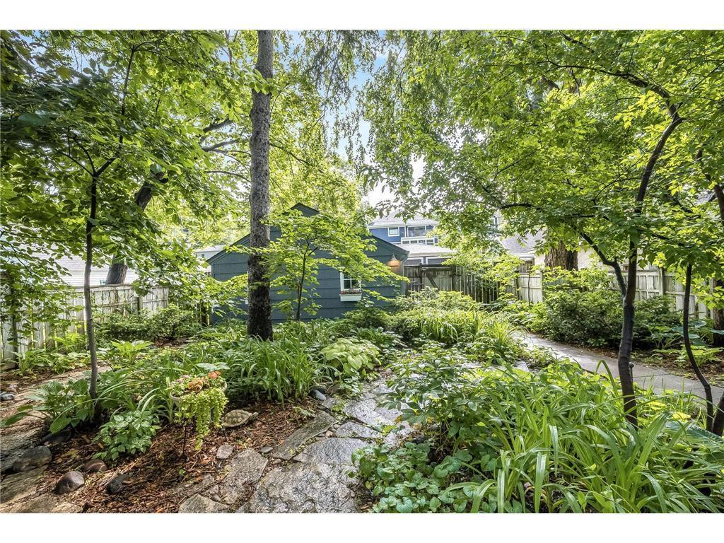 The dreamy backyard is cozy and quiet, filled with perennials for a maintenance free yard