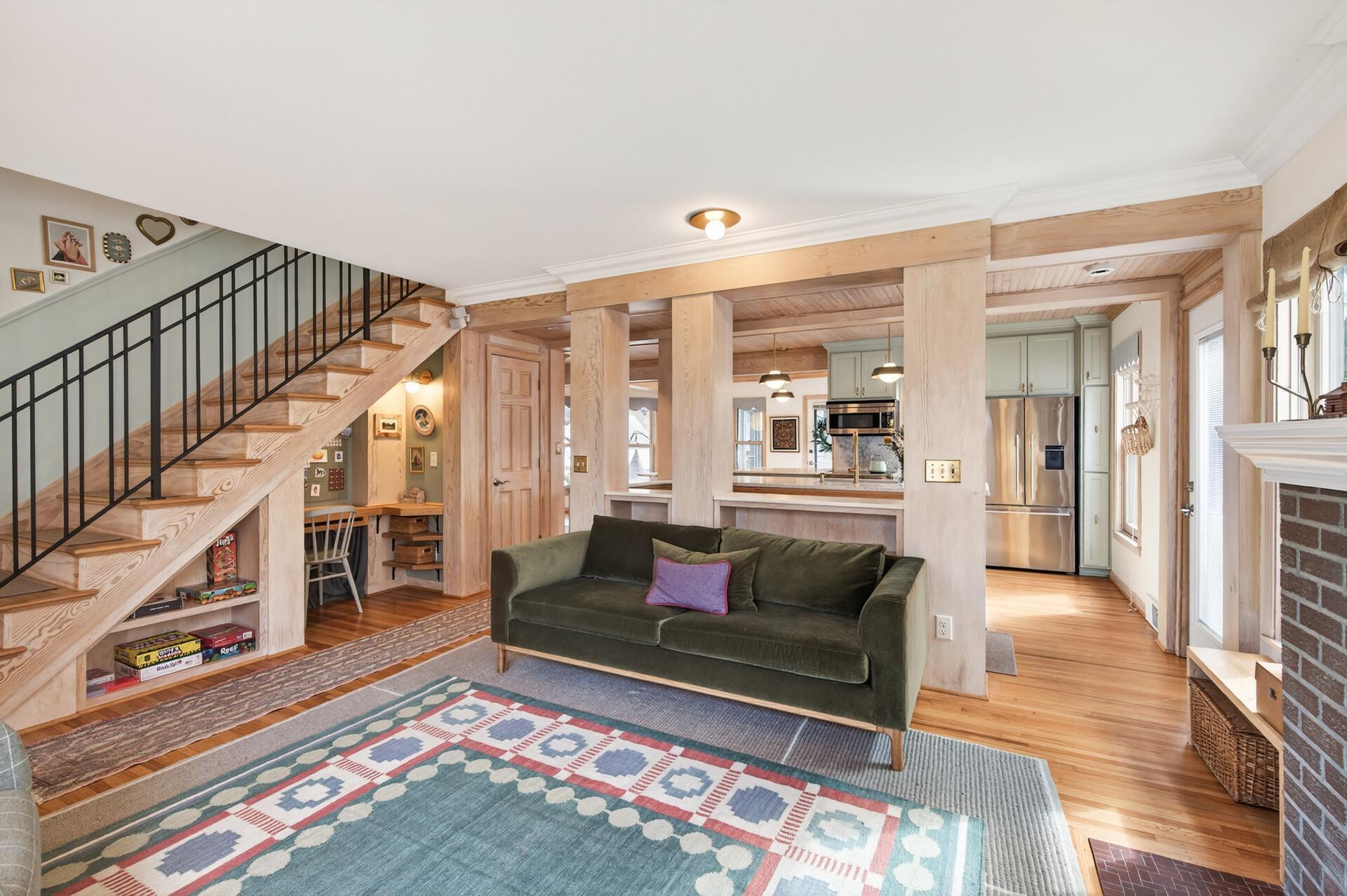 The living room opens into the cheery kitchen! Wait, what's that under the stairs?
