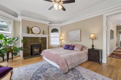 With the arched windows and stunning gas fireplace, the primary bedroom is filled with character.