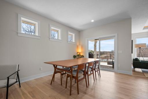 Informal dining room is filled with light & opens to the deck