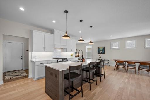 Just off the kitchen, the mudroom and laundry room offer convenient flow and connect directly through to the primary suite