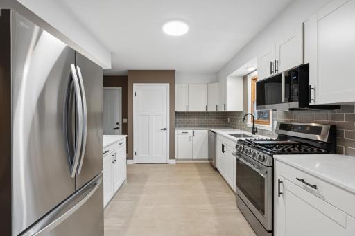 Gorgeous quarts countertops, beautiful white cabinets and amazing gas stove.jpg