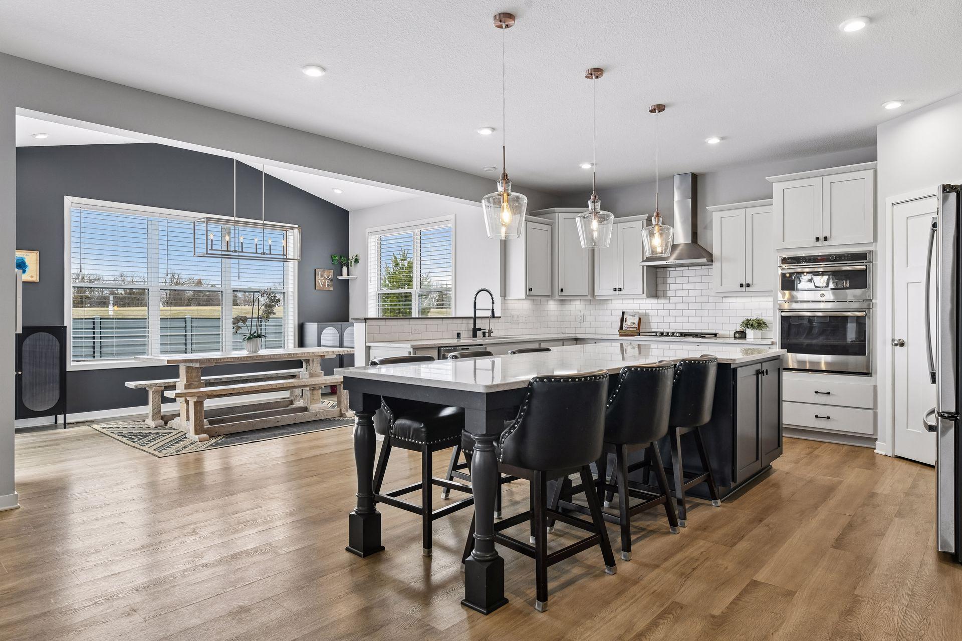 Built for the way people actually cook and entertain. Extended island, GE appliances, convection microwave with vented hood, touchless faucet, and under-cabinet lighting, all with western lake views out the window.