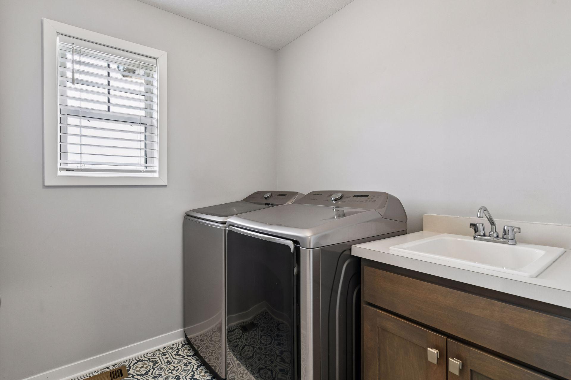 Upper level laundry offers new washer/dryer and utility sink