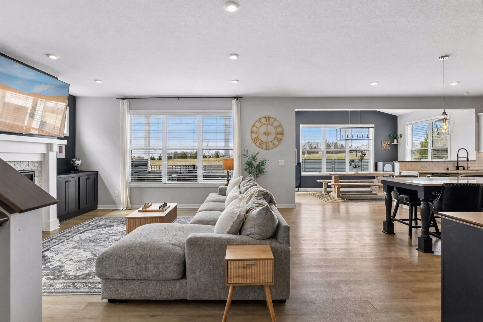 Open concept living at its finest. LVP floors throughout the entire main level, windows framing the entire back wall make this space light open and airy.