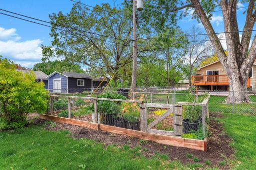 Landscaped garden beds enhance the property with layered plantings, tidy borders, and healthy greenery.