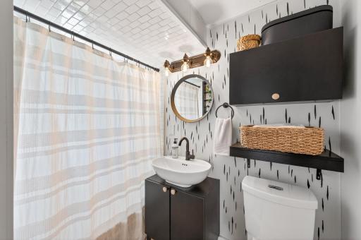 Beautifully updated bathroom with subway tile, new toilet, and stylish vanity with great storage.