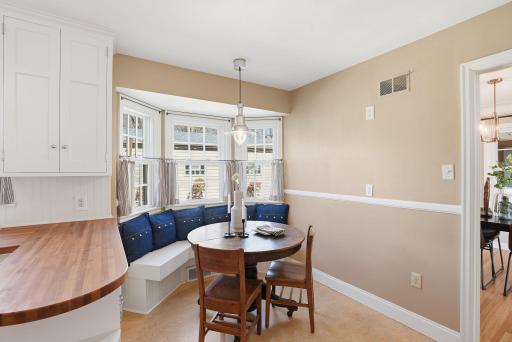 Bay window dining nook looks out to backyard