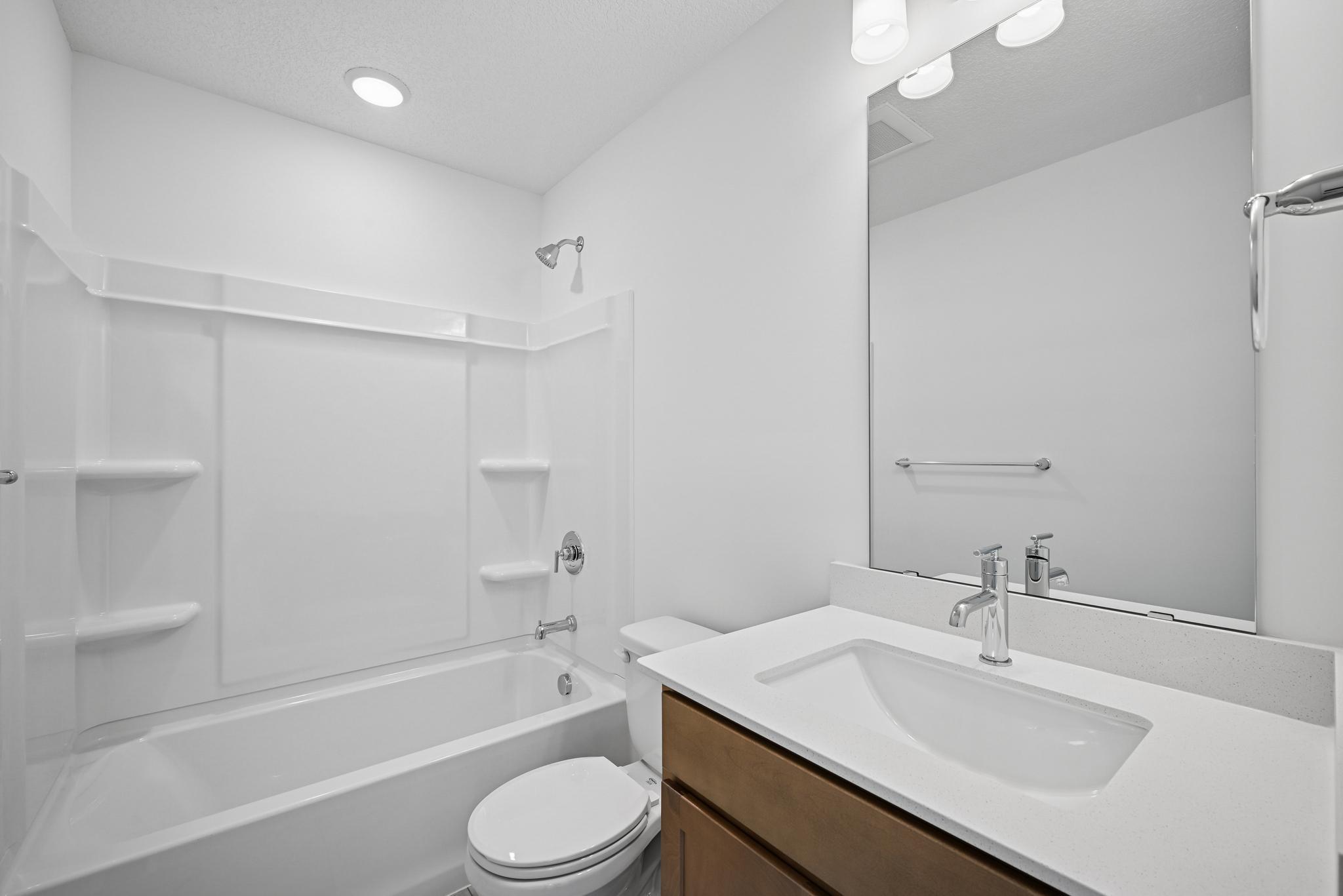 The secondary bathroom is conveniently located to serve the additional bedrooms, offering a practical and comfortable space for daily routines. **Photo of similar home**